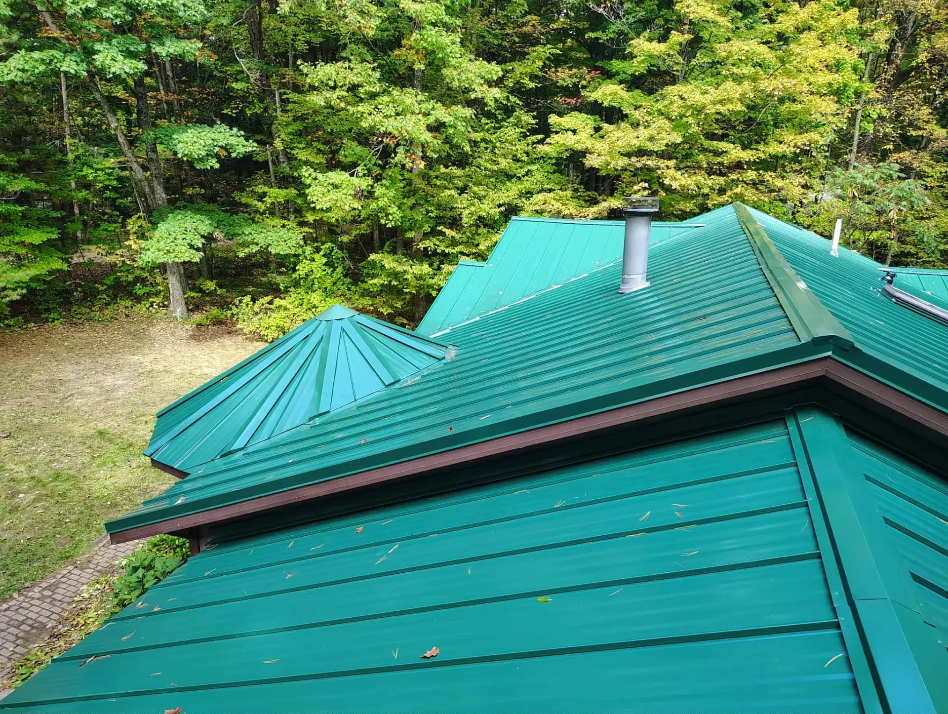 Green metal roof after storm damage roof repair in Grant, MI.